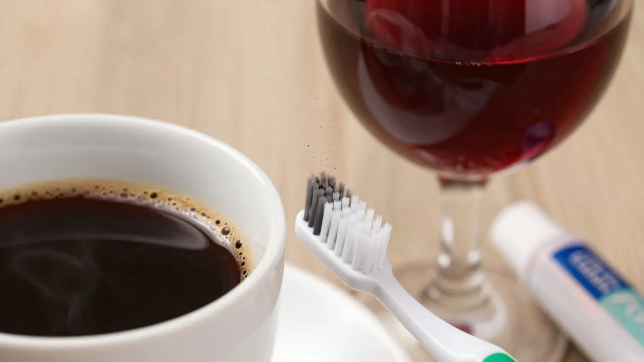 Káva a víno vedle zubní hygieny symbolizující příčiny skvrn